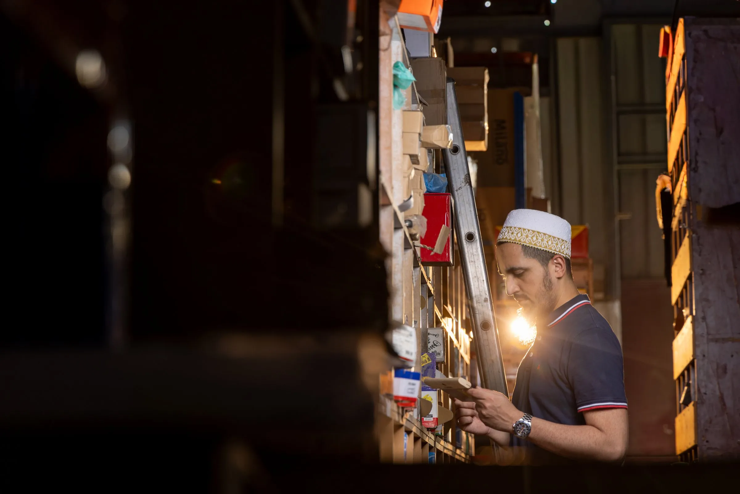 Checking stock in a warehouse aisle